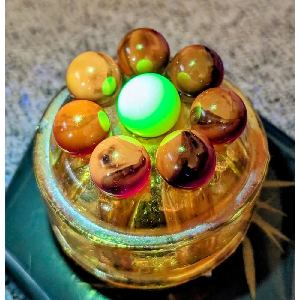 7 Red Cadmium Marbles W/ 1 Burmese Marble On VTG Flower Frog. (Included)
